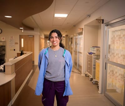 Staff member smiling in a facility hallway