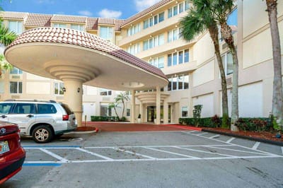 Entrance of senior living facility with outdoor parking