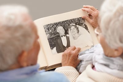 Elderly couple looking at a wedding photo album