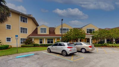 Exterior view of Aventura Bay Place with parked cars