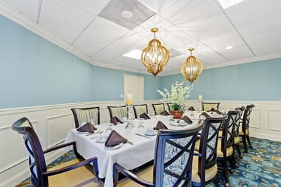 Elegant dining room set for a meal with floral centerpiece
