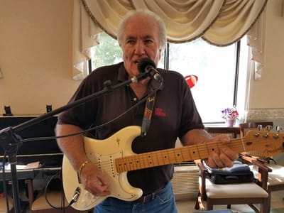 Resident performing music in a common area