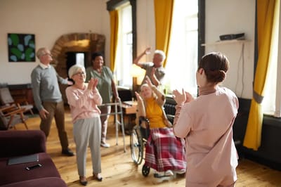 Residents participating in an activity with staff guidance