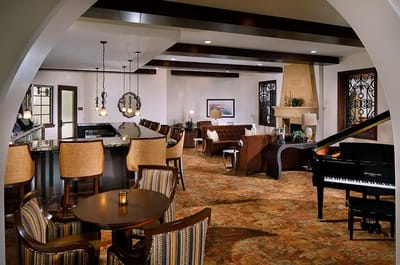 A cozy lounge area with seating and a piano