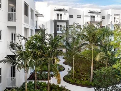 Lush landscaping surrounding a pathway in a senior living facility