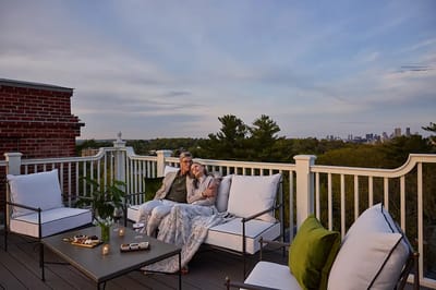 Couple relaxing on a terrace with city view