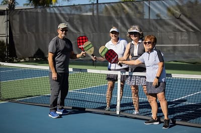 Residents enjoying a game of pickleball outdoors
