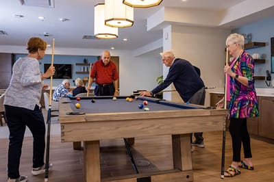 Residents playing billiards in a common area