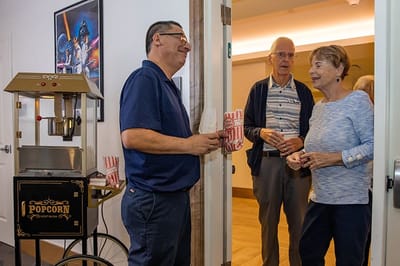 Residents enjoying popcorn in a common area