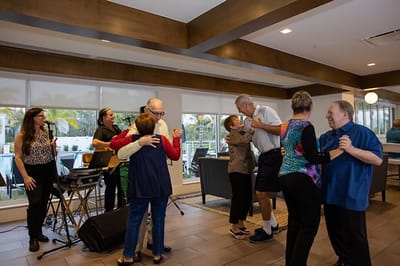Residents enjoying a dance activity in a common area