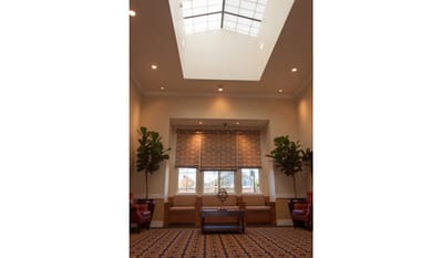 An interior view of a facility lounge with skylight