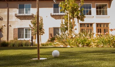 Close-up of a golf ball on a putting green outside