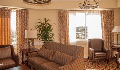 Bright interior common area with seating and curtains
