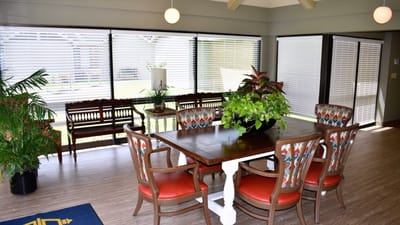 Bright common area with dining table and chairs