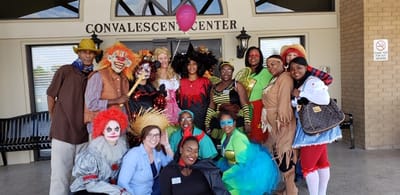 Residents and staff in costumes outside the Convalescent Center