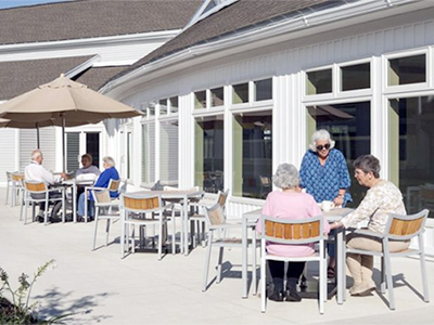 Residents enjoying time outdoors at tables