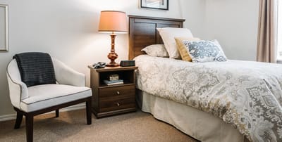Cozy bedroom with decorative bedding and lamp