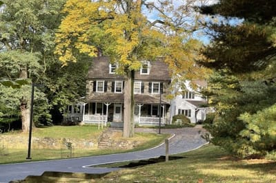 Exterior view of a senior living facility with autumn leaves