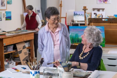 Residents engaging in an art activity in a common area