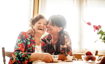Two women sharing a joyful moment indoors