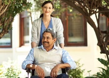 Grace Barker Nursing Center, Nursing Home in Warren, RI — Caregiver assisting a smiling resident in a garden