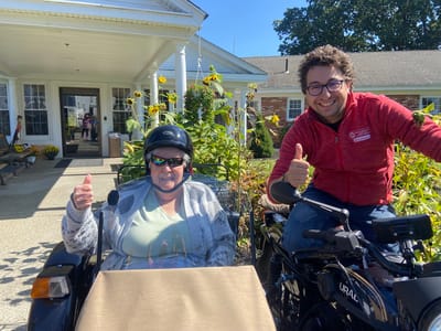 Residents enjoying outdoor time with staff members