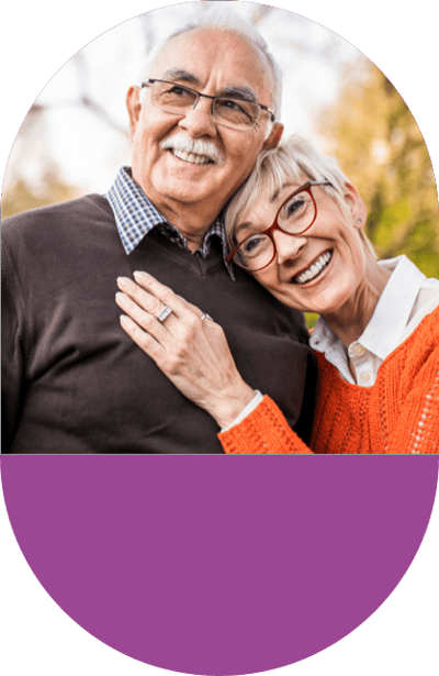Smiling older couple, outdoor background