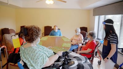 Residents enjoying a bingo game in common area