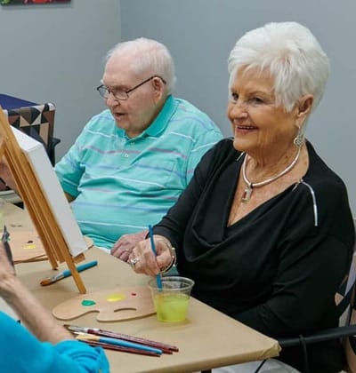 Residents painting during an art activity session