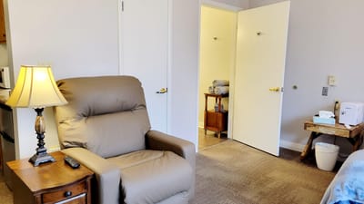 Cozy private resident room with a comfortable chair