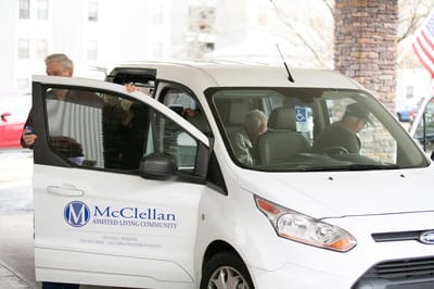 Residents entering a facility vehicle outside