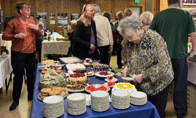 Residents enjoying a social event with a variety of foods