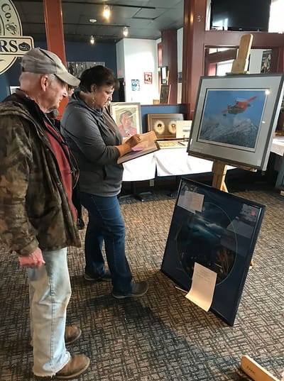 Residents engaging with artwork in a common area