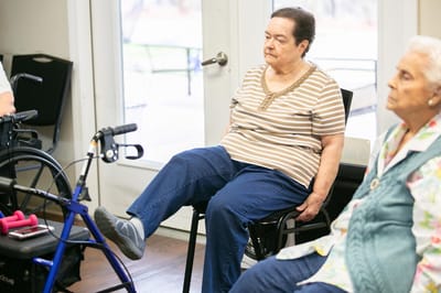 Residents participating in a seated exercise class