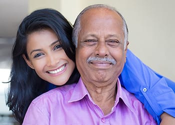 Enterprise Health & Rehabilitation Center, Nursing Home in Enterprise, AL — Smiling woman embracing elderly man in a bright setting