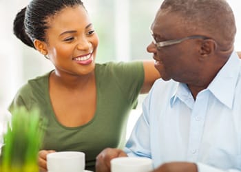 Enterprise Health & Rehabilitation Center, Nursing Home in Enterprise, AL — Smiling caregiver and senior resident enjoying coffee together