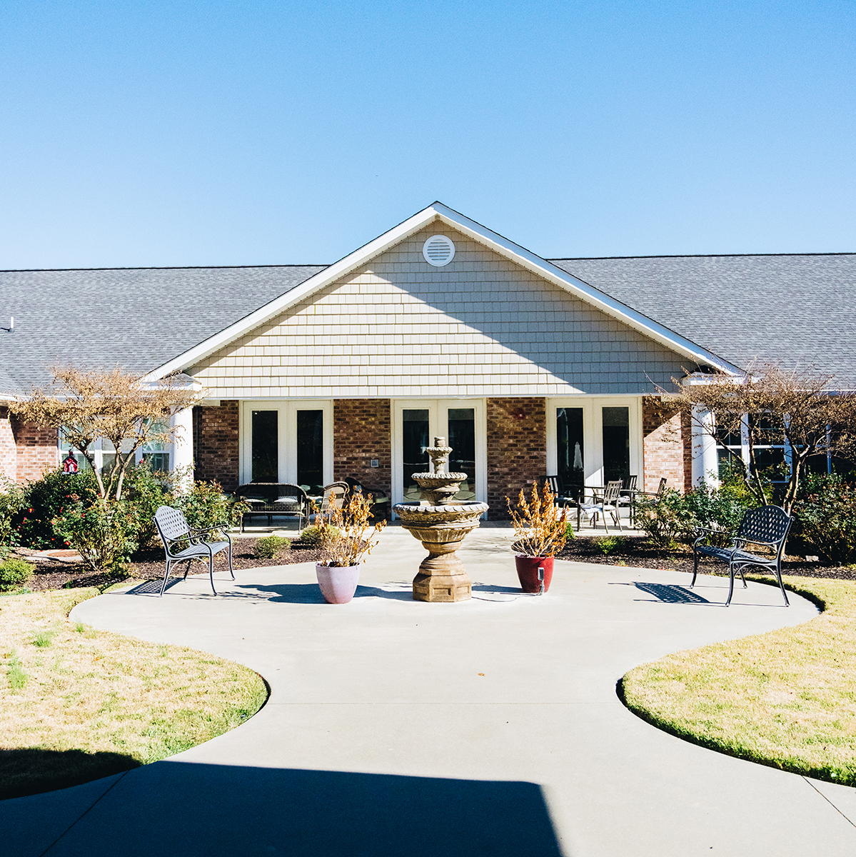 Outdoor view of the facility entrance with a fountain
