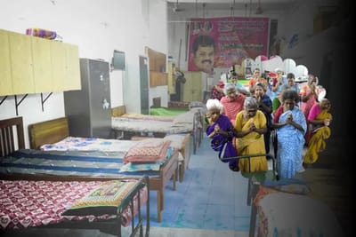 Residents in an interior common area praying together