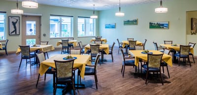 Bright dining room with tables set for meals