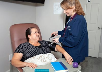Healthcare staff taking a resident's blood pressure