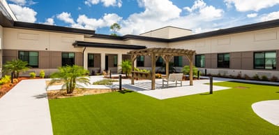 Outdoor courtyard with seating area and landscaping