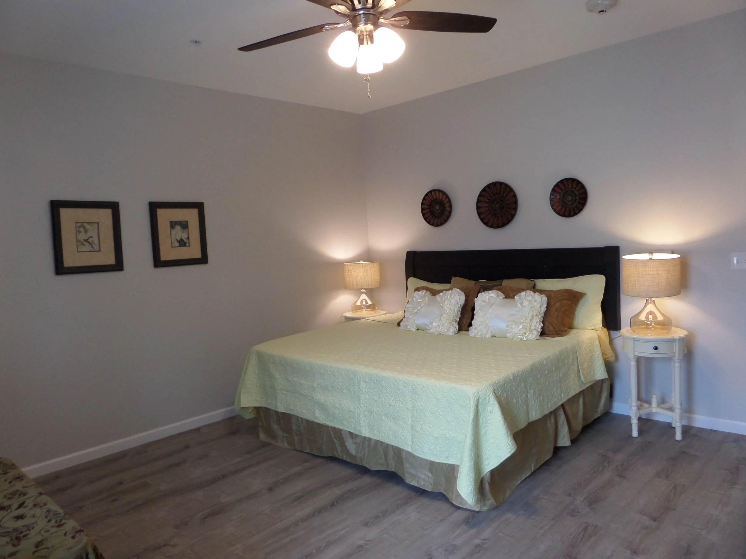 Well-decorated private resident room with a bed and lamps