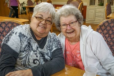 Peachtree Village Retirement & Assisted Living Communities, senior communitie in Fort Smith, AR — Two smiling elderly women posing together at a
