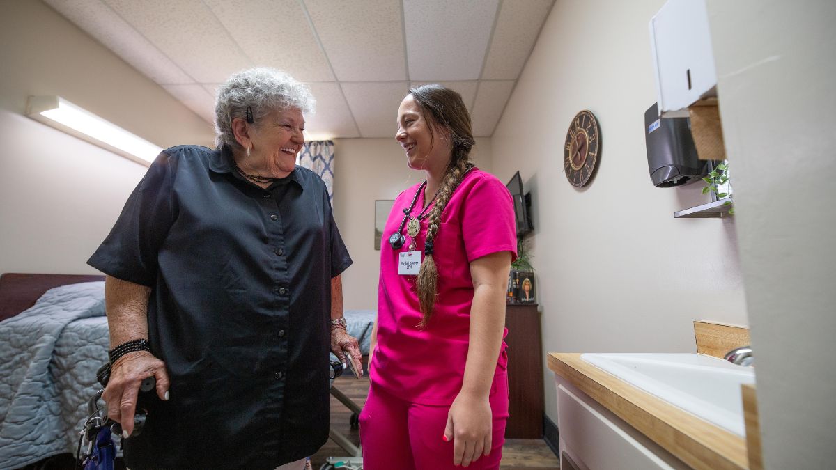 Staff interacting with a resident in a room