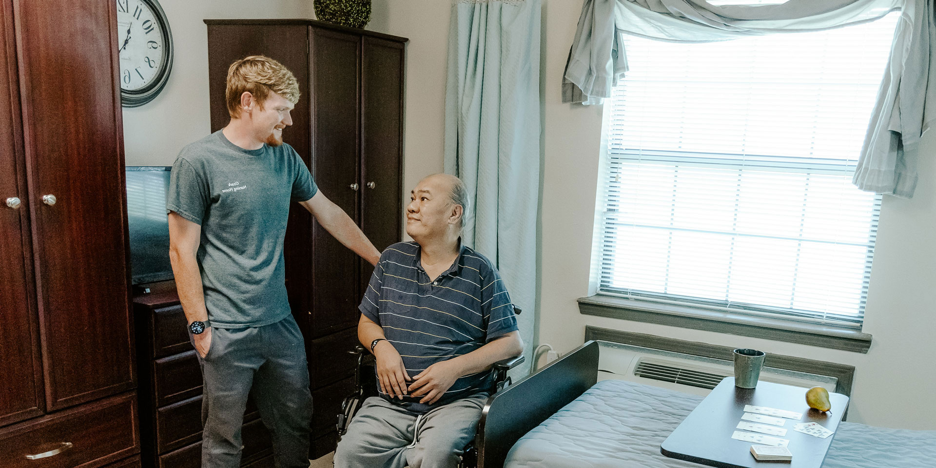 Staff member talking with a resident in a room