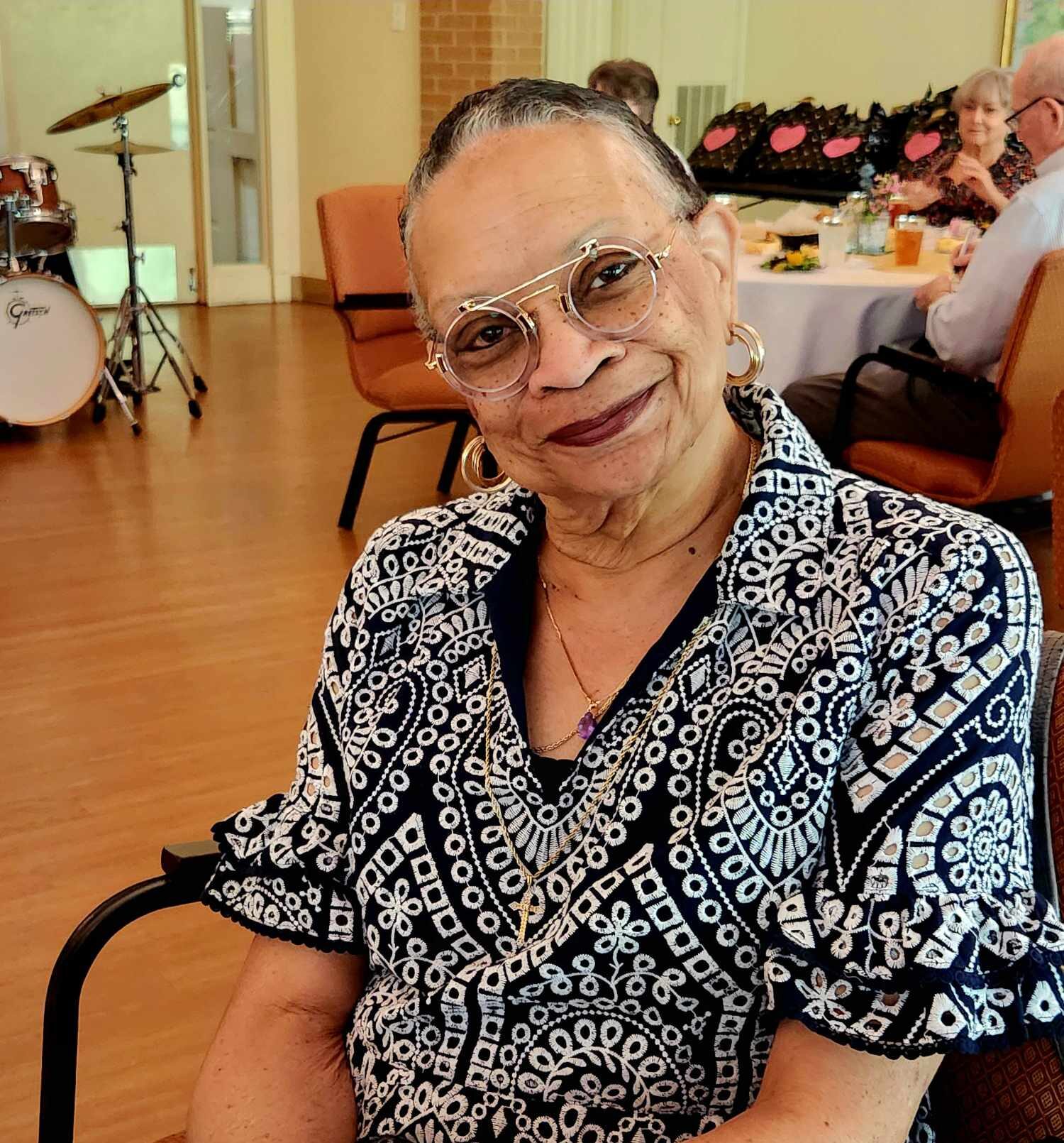 Resident smiling during an event in the common area