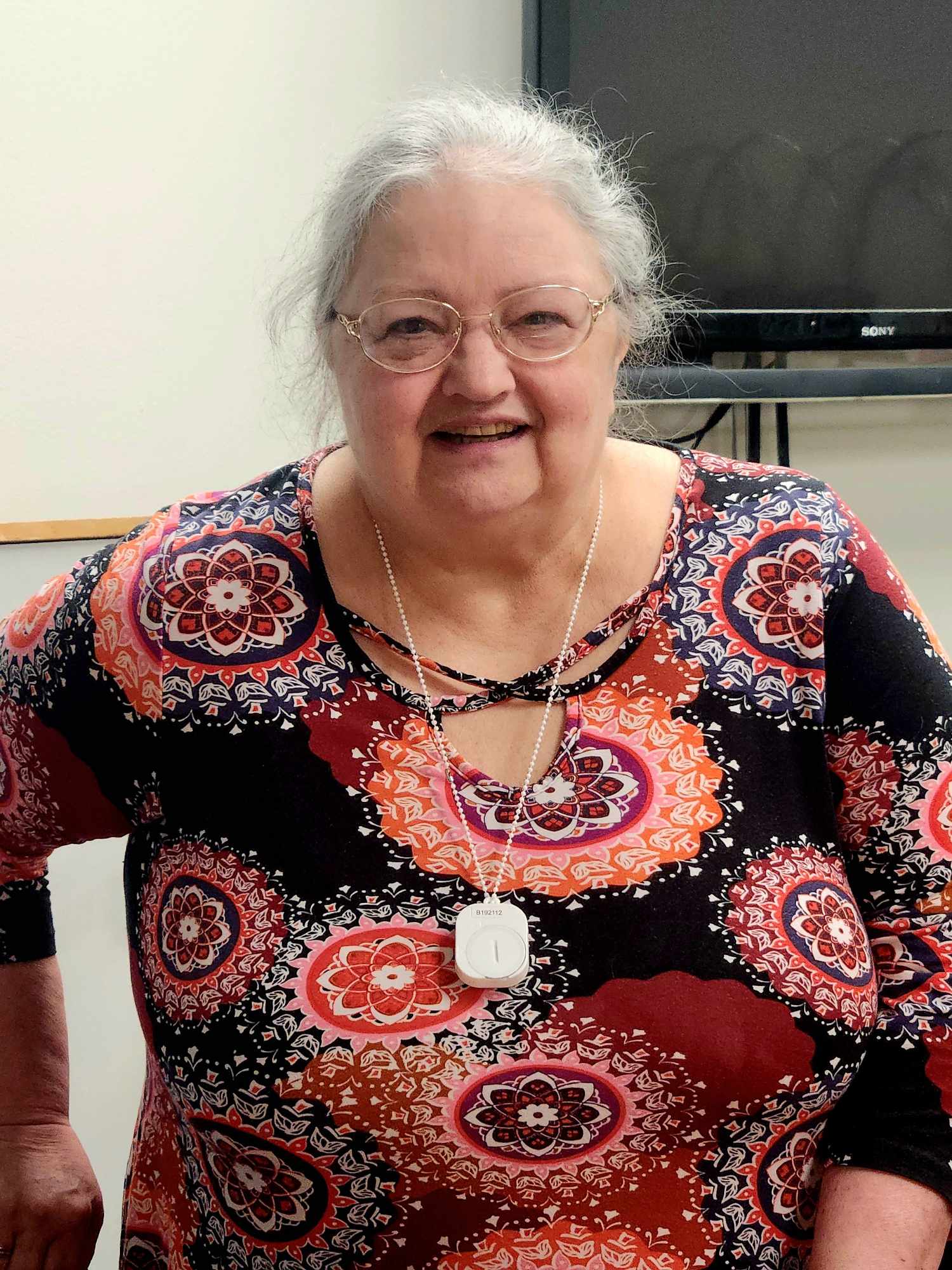 Resident smiling in a colorful outfit