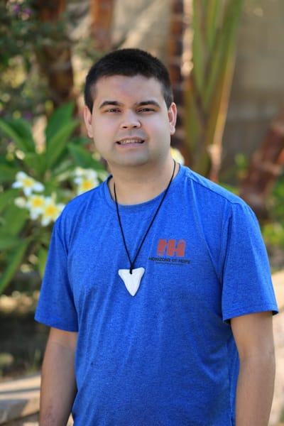 Staff member in a garden setting at Horizons of Hope