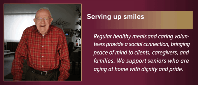Elderly man smiling in a cozy room