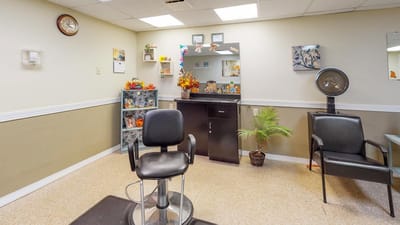 Interior view of a salon with styling chair and mirror